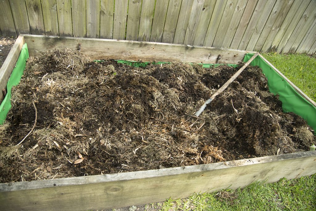 A compost pile of dead grass clippings and other organic matter